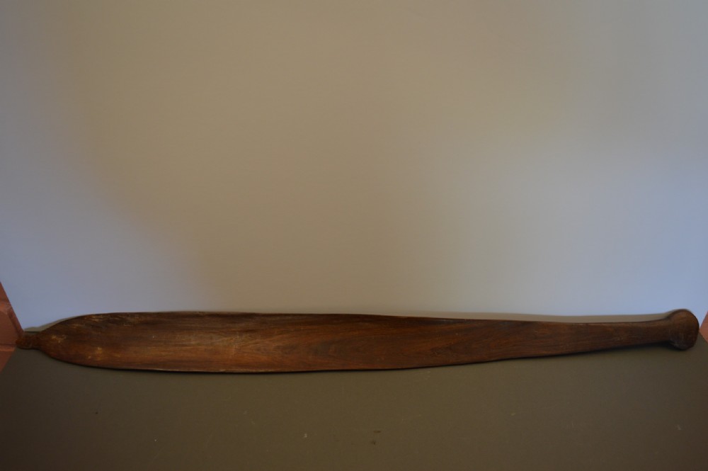 A pair of 19th-century carved Indigenous Australian wooden woomeras displaying elongated curved profiles and natural timber grain. View II