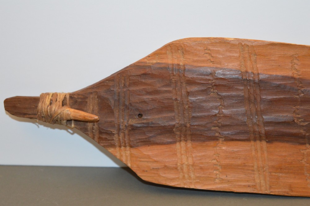 A pair of 19th-century carved Indigenous Australian wooden woomeras displaying elongated curved profiles and natural timber grain. View VII