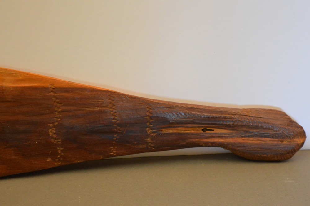 A pair of 19th-century carved Indigenous Australian wooden woomeras displaying elongated curved profiles and natural timber grain. View IX