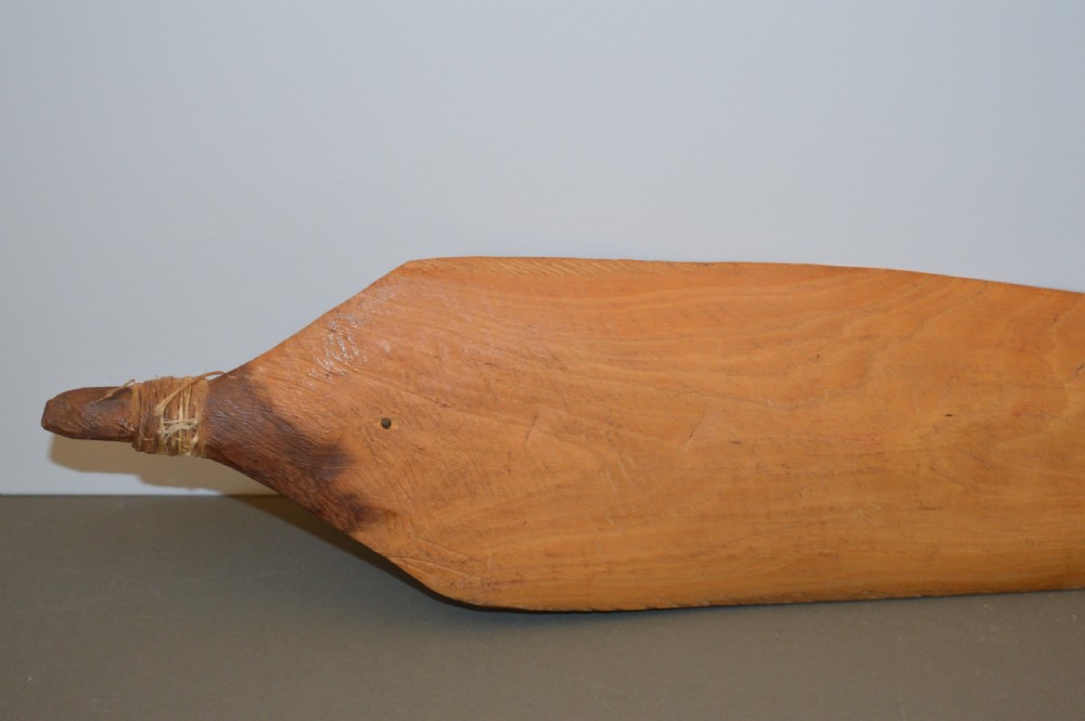 A pair of 19th-century carved Indigenous Australian wooden woomeras displaying elongated curved profiles and natural timber grain. View XI