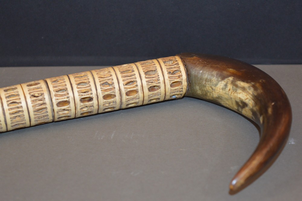 An antique Victorian walking stick featuring a shaft constructed from stacked shark vertebrae and topped with a curved dark horn handle. View II