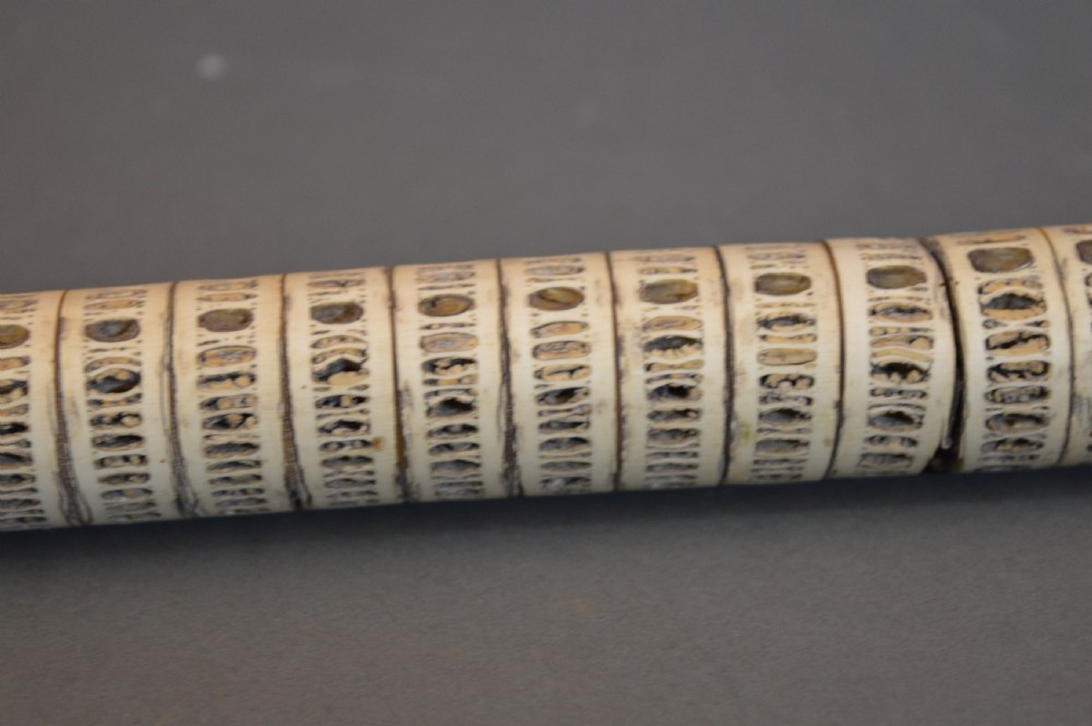 An antique Victorian walking stick featuring a shaft constructed from stacked shark vertebrae and topped with a curved dark horn handle. View IV