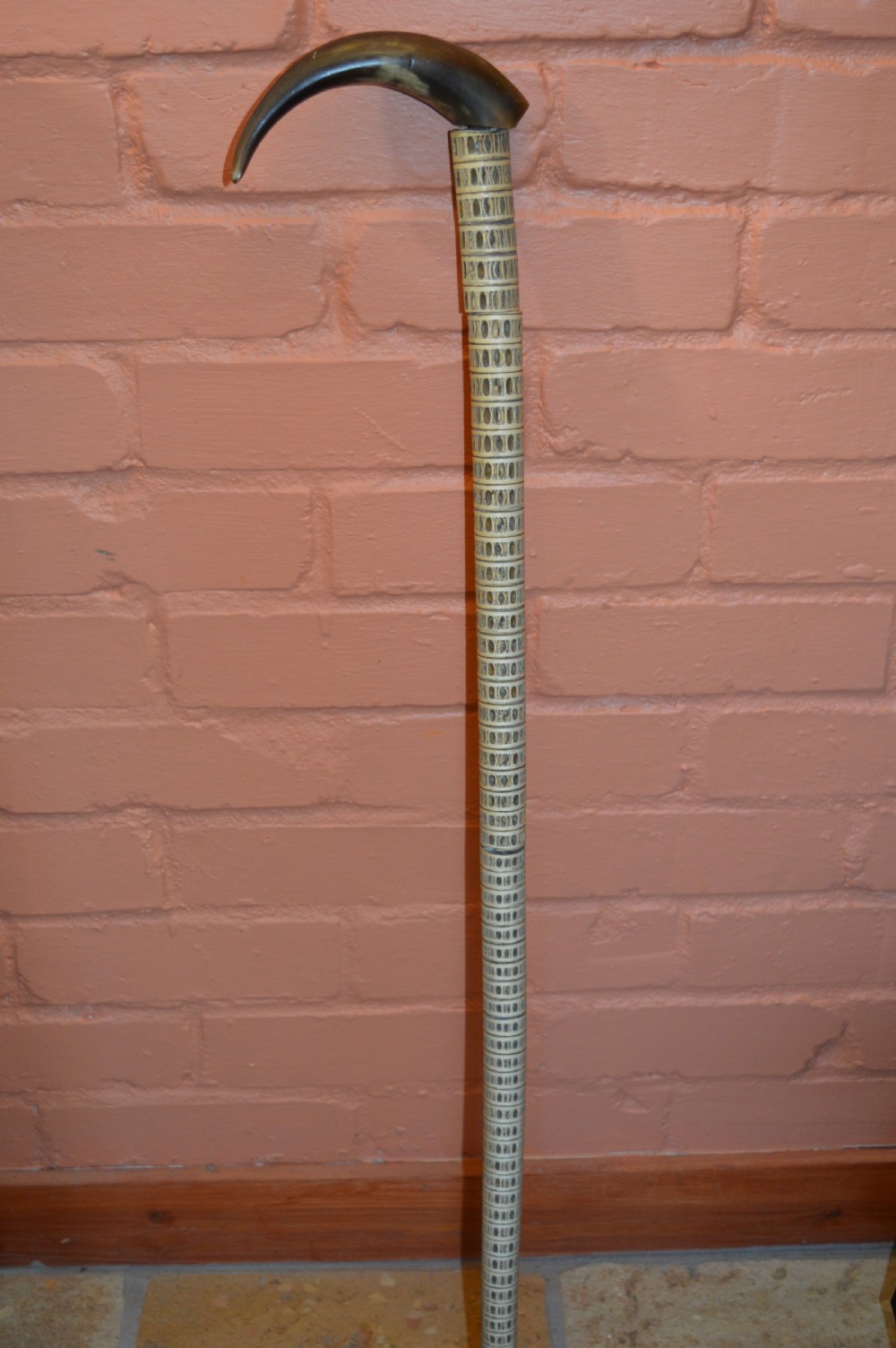 An antique Victorian walking stick featuring a shaft constructed from stacked shark vertebrae and topped with a curved dark horn handle. View VII