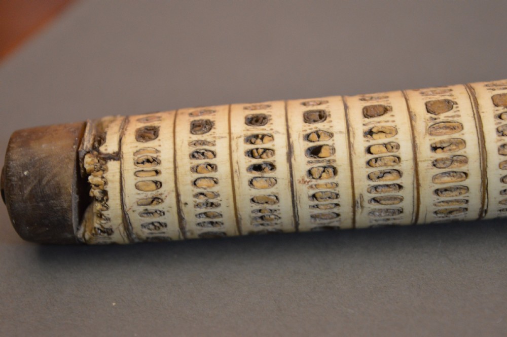 An antique Victorian walking stick featuring a shaft constructed from stacked shark vertebrae and topped with a curved dark horn handle. View VIII