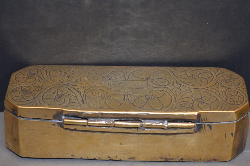 An elongated Georgian brass tobacco box featuring hand-engraved floral motifs, canted corners, and a hinged lid. View III