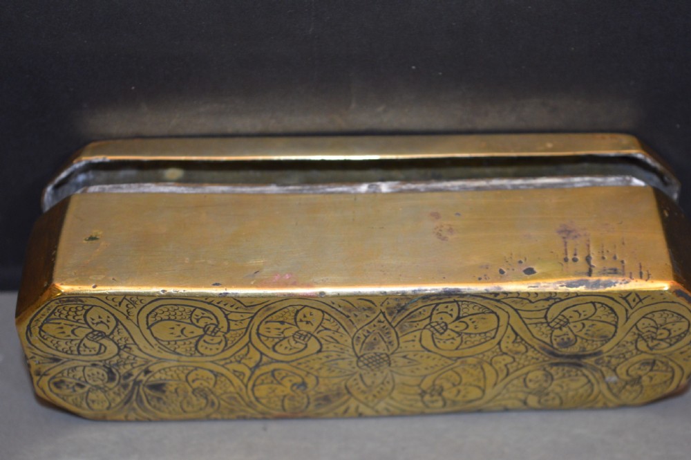 An elongated Georgian brass tobacco box featuring hand-engraved floral motifs, canted corners, and a hinged lid. View VIII