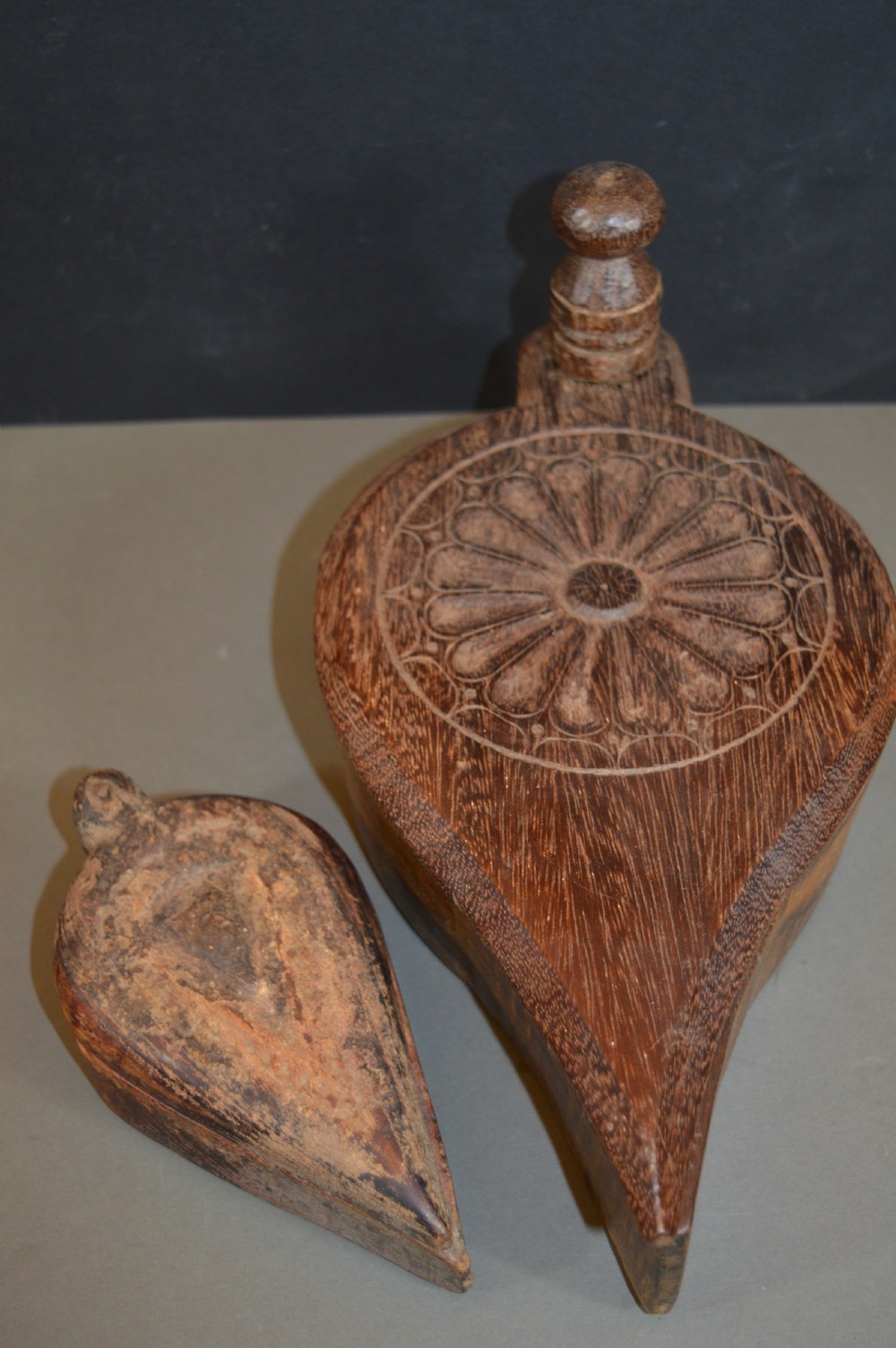 Pair of 19th-century Indian hand-carved teardrop-shaped hardwood spice boxes featuring intricate floral rosette motifs and a turned wood knob. View VIII