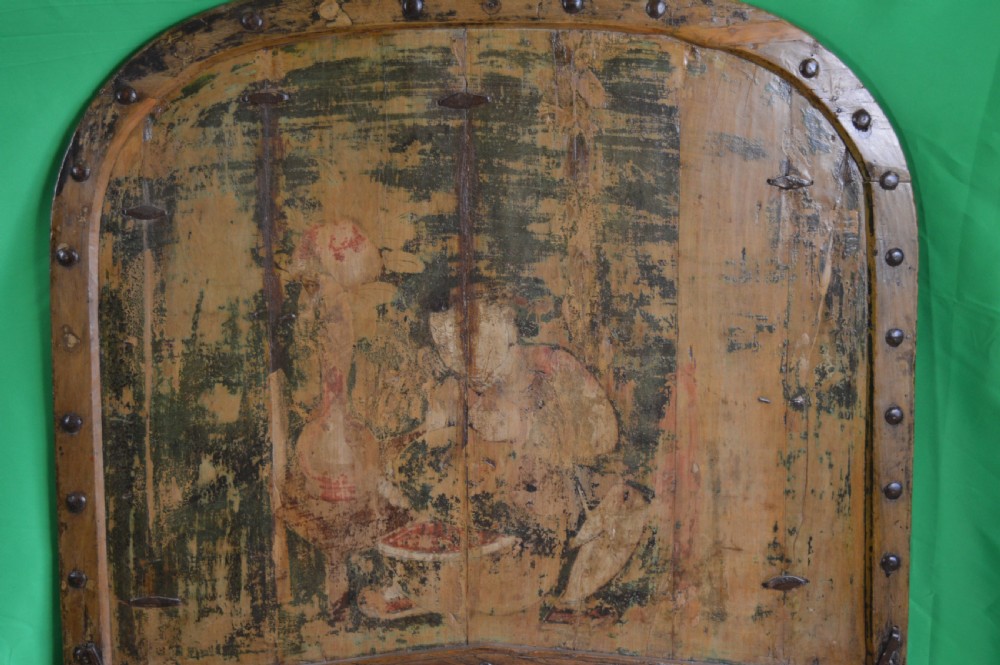 An arched antique Chinese wooden cart door featuring faded hand-painted figures, weathered green pigments, and iron studs. View II