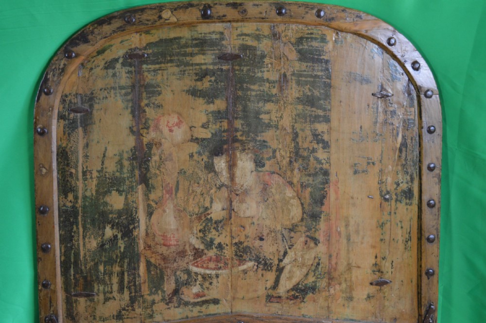 An arched antique Chinese wooden cart door featuring faded hand-painted figures, weathered green pigments, and iron studs. View X