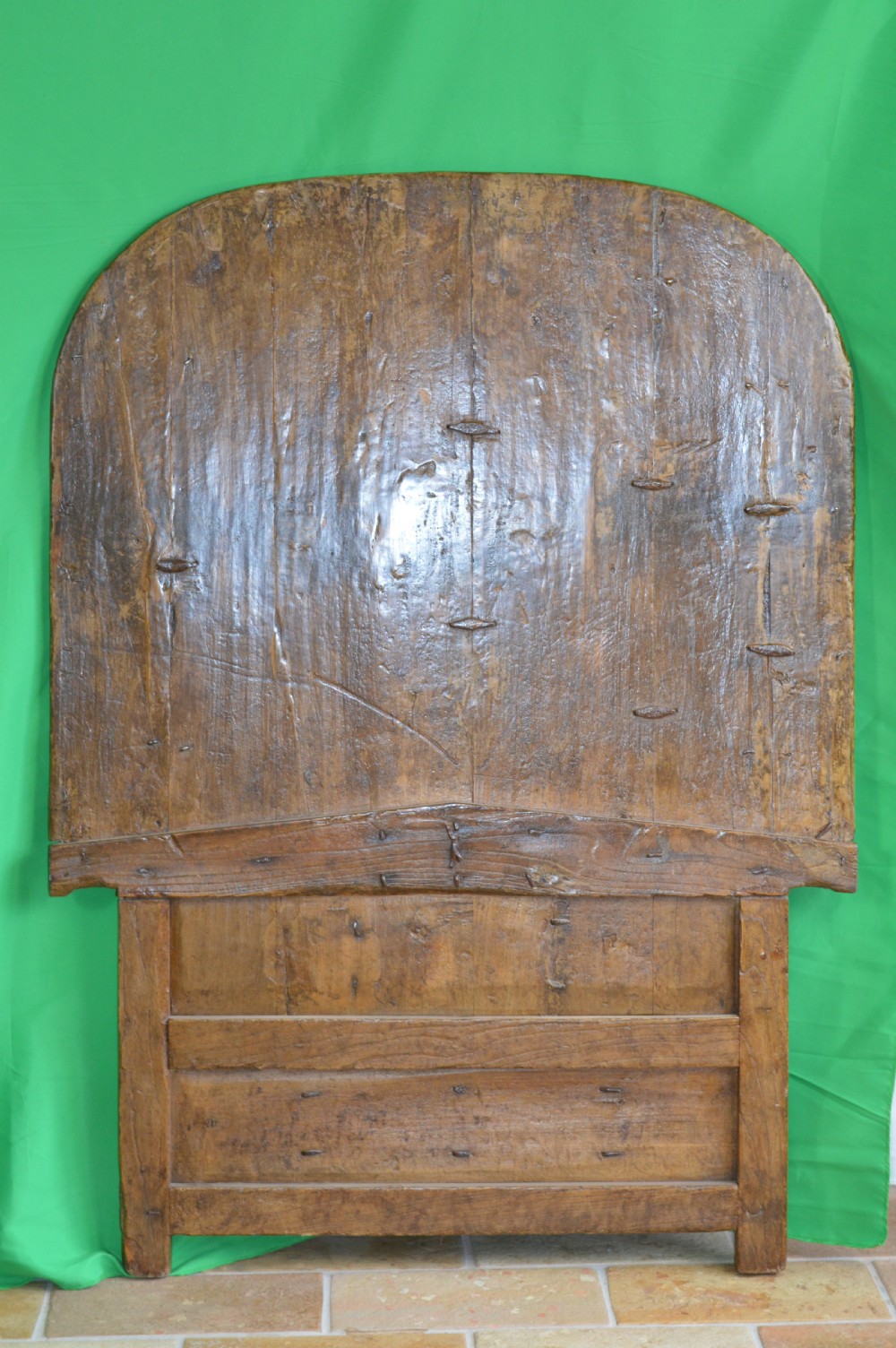 An arched antique Chinese wooden cart door featuring faded hand-painted figures, weathered green pigments, and iron studs. View XV