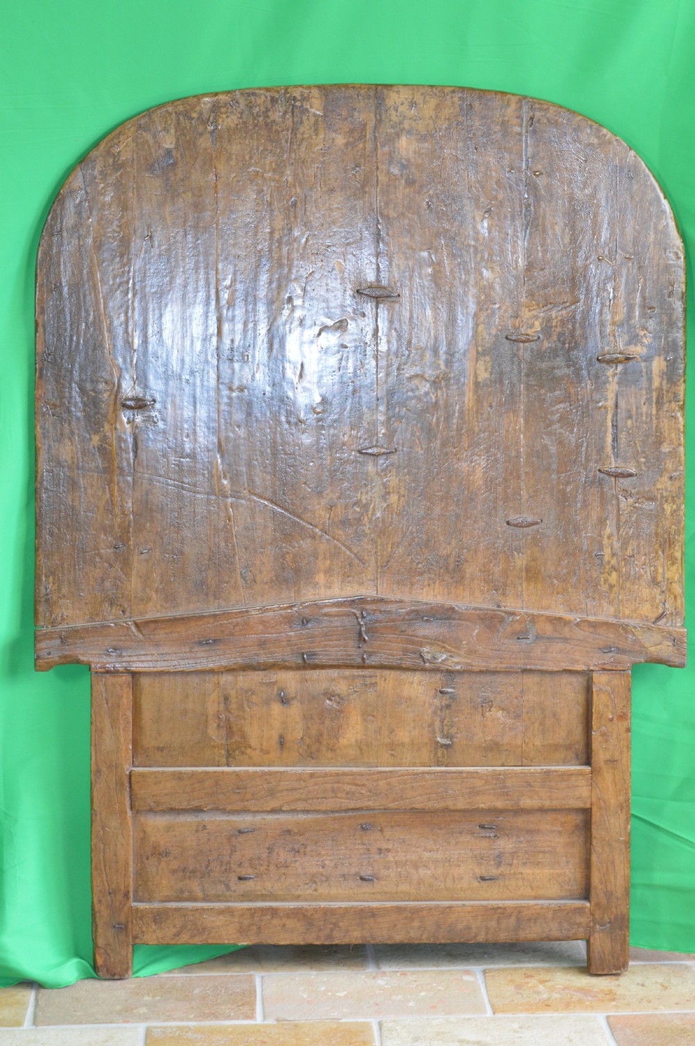 An arched antique Chinese wooden cart door featuring faded hand-painted figures, weathered green pigments, and iron studs. View XVI