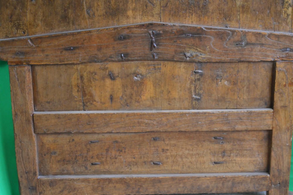An arched antique Chinese wooden cart door featuring faded hand-painted figures, weathered green pigments, and iron studs. View XVIII