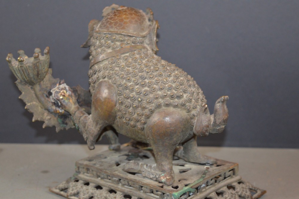 A late 18th-century Chinese bronze incense burner in the shape of a mythical Qilin creature with an open mouth standing on a pierced rectangular stand. View VII