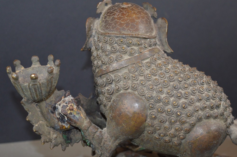 A late 18th-century Chinese bronze incense burner in the shape of a mythical Qilin creature with an open mouth standing on a pierced rectangular stand. View VIII