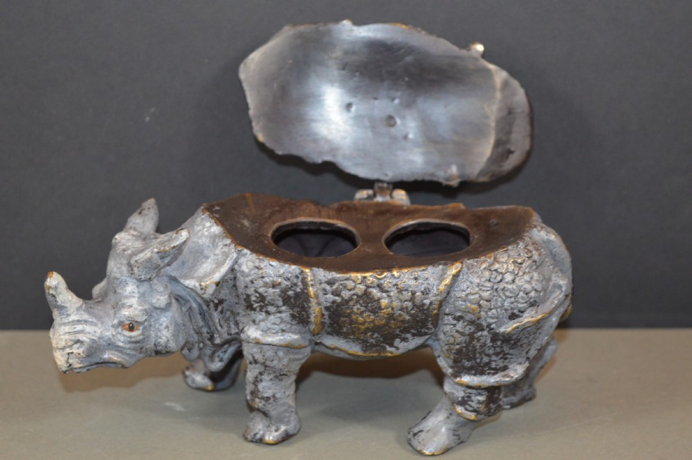 An antique Austrian cold-painted bronze inkwell cast in the detailed form of a standing rhinoceros with a hinged opening back. View III