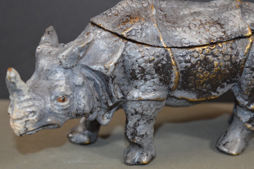 An antique Austrian cold-painted bronze inkwell cast in the detailed form of a standing rhinoceros with a hinged opening back. View V