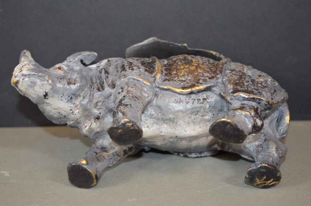 An antique Austrian cold-painted bronze inkwell cast in the detailed form of a standing rhinoceros with a hinged opening back. View VI