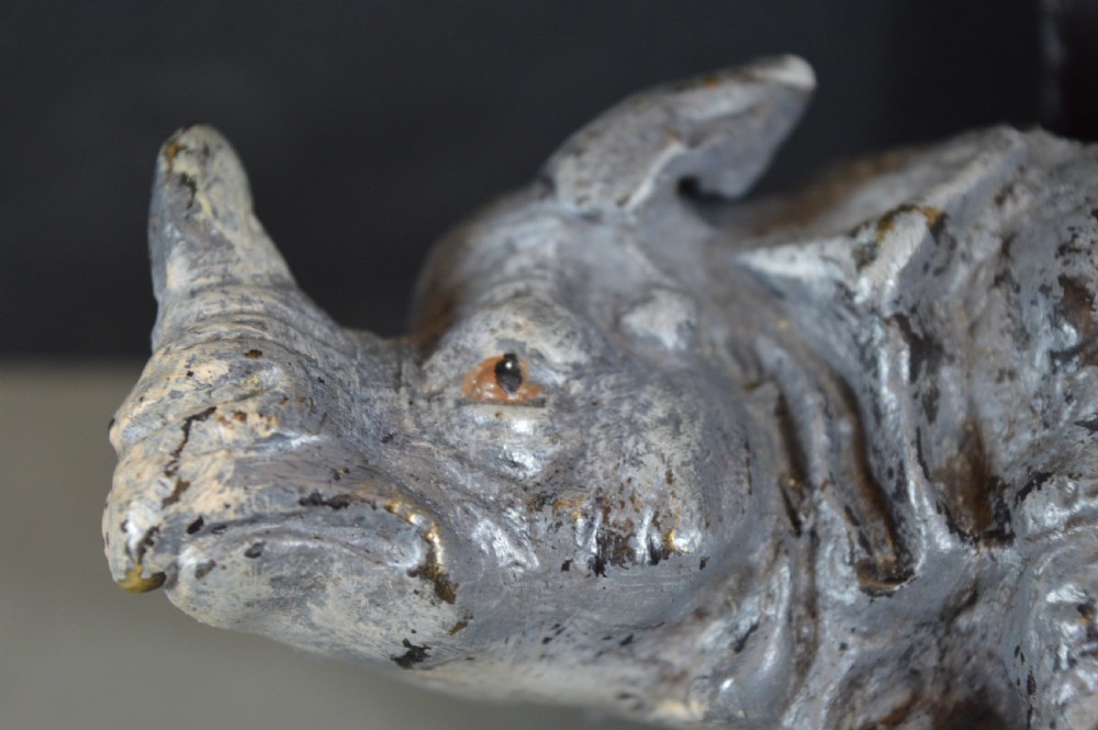 An antique Austrian cold-painted bronze inkwell cast in the detailed form of a standing rhinoceros with a hinged opening back. View VII