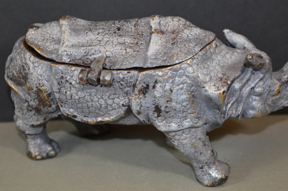An antique Austrian cold-painted bronze inkwell cast in the detailed form of a standing rhinoceros with a hinged opening back. View VIII