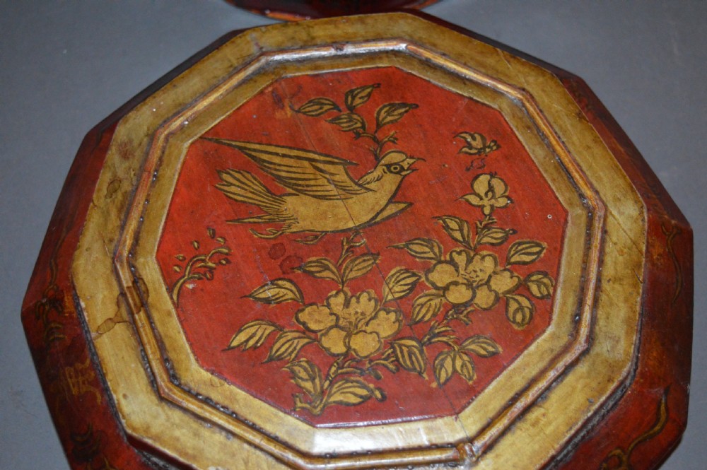 A red hand-painted Chinese wooden rice carrier featuring an arched overhead handle, lidded faceted body, and depictions of waterbirds and fish. View XI