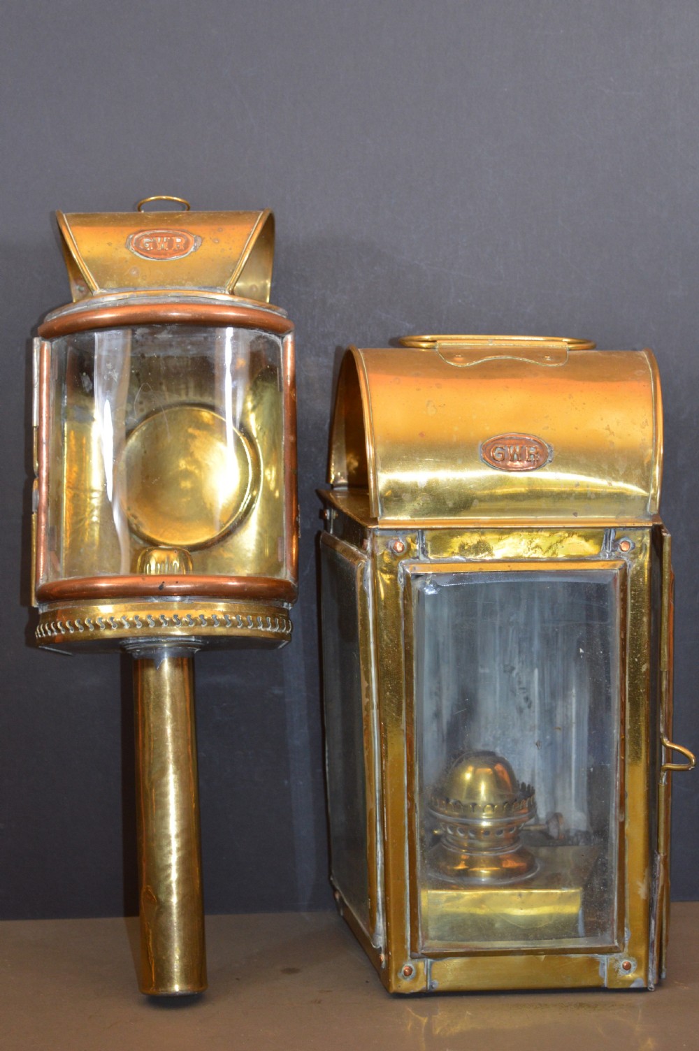 A pair of 19th-century GWR brass and copper railway carriage oil lamps featuring engraved oval GWR plaques.