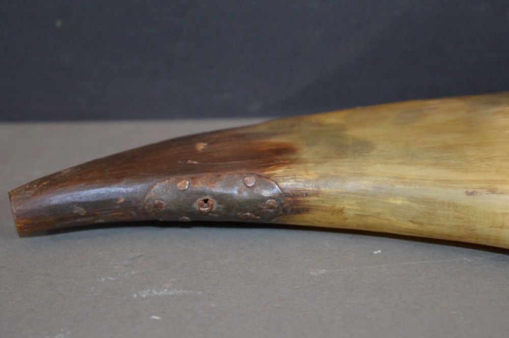 An 18th-century natural curved horn powder flask featuring a fitted wooden base plug pinned with iron tacks and a tapered spout. View III