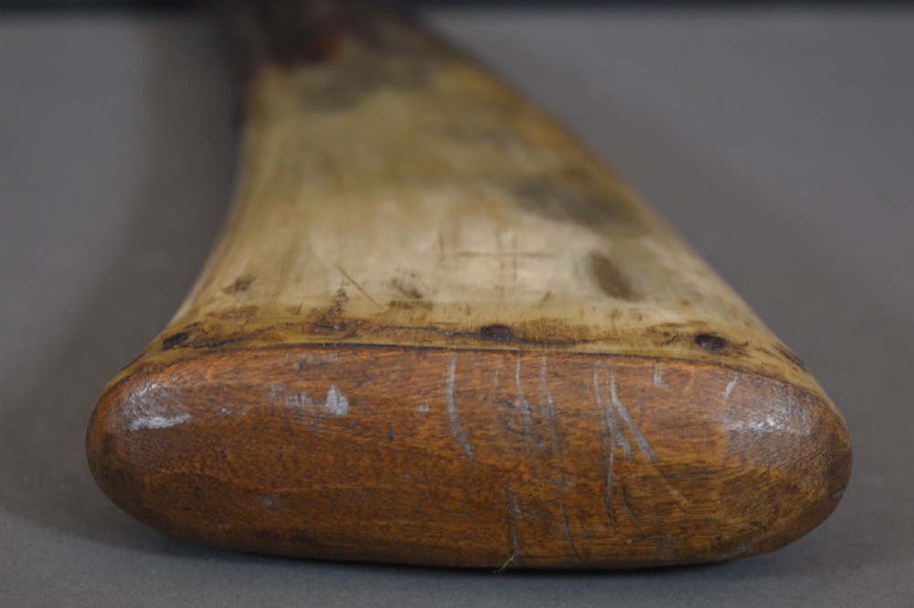 An 18th-century natural curved horn powder flask featuring a fitted wooden base plug pinned with iron tacks and a tapered spout. View IV