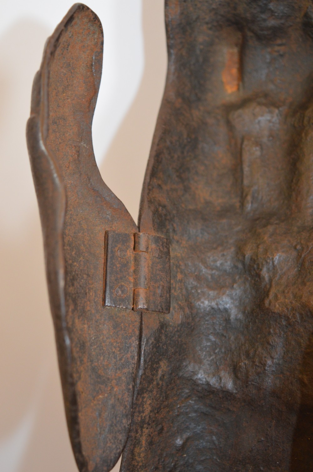 A pair of 19th-century articulated iron armour gauntlets with layered finger plates, flared cuffs, and visible rivets with an oxidised patina. View X