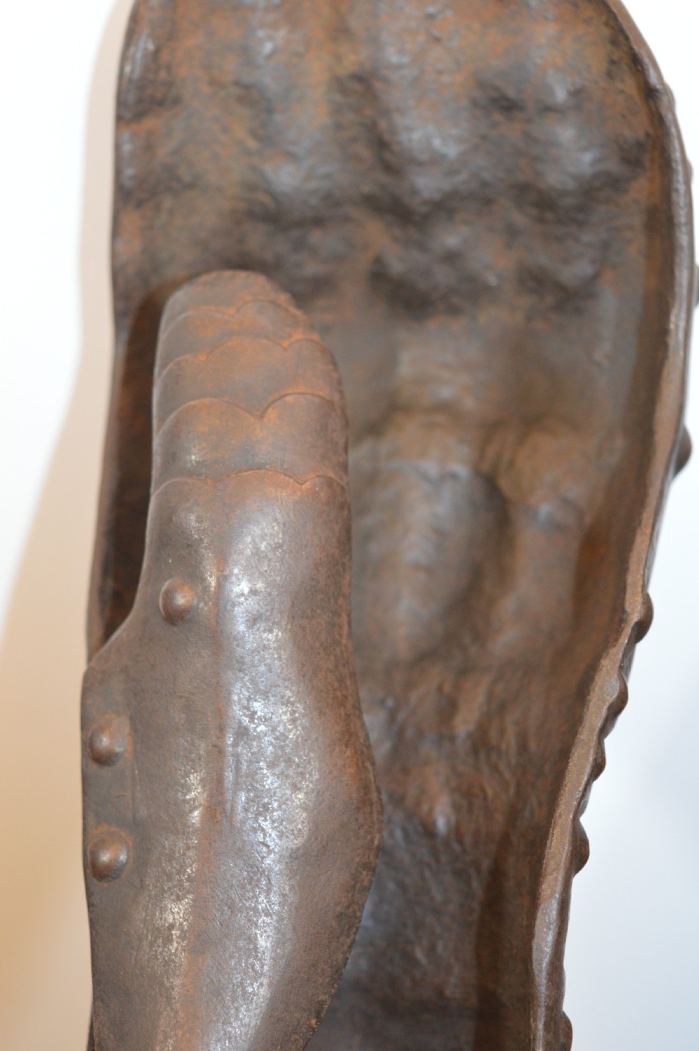A pair of 19th-century articulated iron armour gauntlets with layered finger plates, flared cuffs, and visible rivets with an oxidised patina. View XI