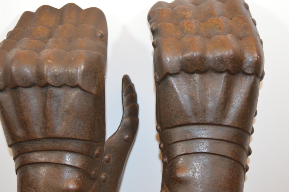 A pair of 19th-century articulated iron armour gauntlets with layered finger plates, flared cuffs, and visible rivets with an oxidised patina. View XIII
