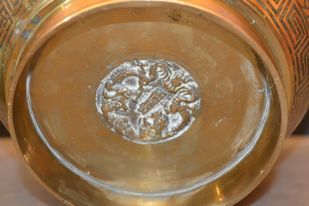 A heavy polished brass Japanese jardiniere with incised dragon artwork and geometric key fret borders around the exterior. View V