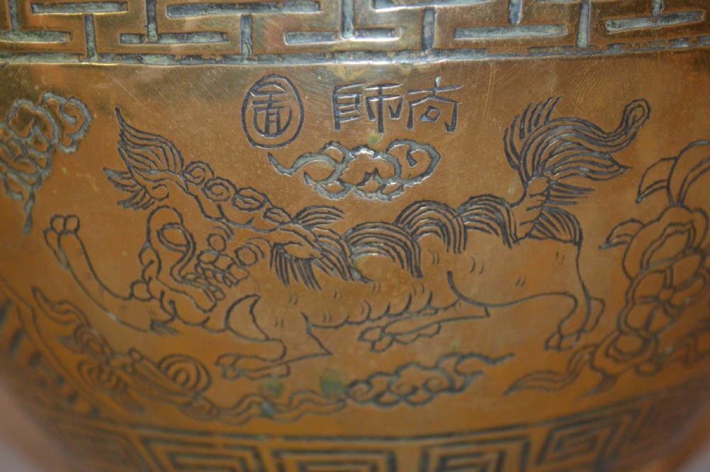A heavy polished brass Japanese jardiniere with incised dragon artwork and geometric key fret borders around the exterior. View VI