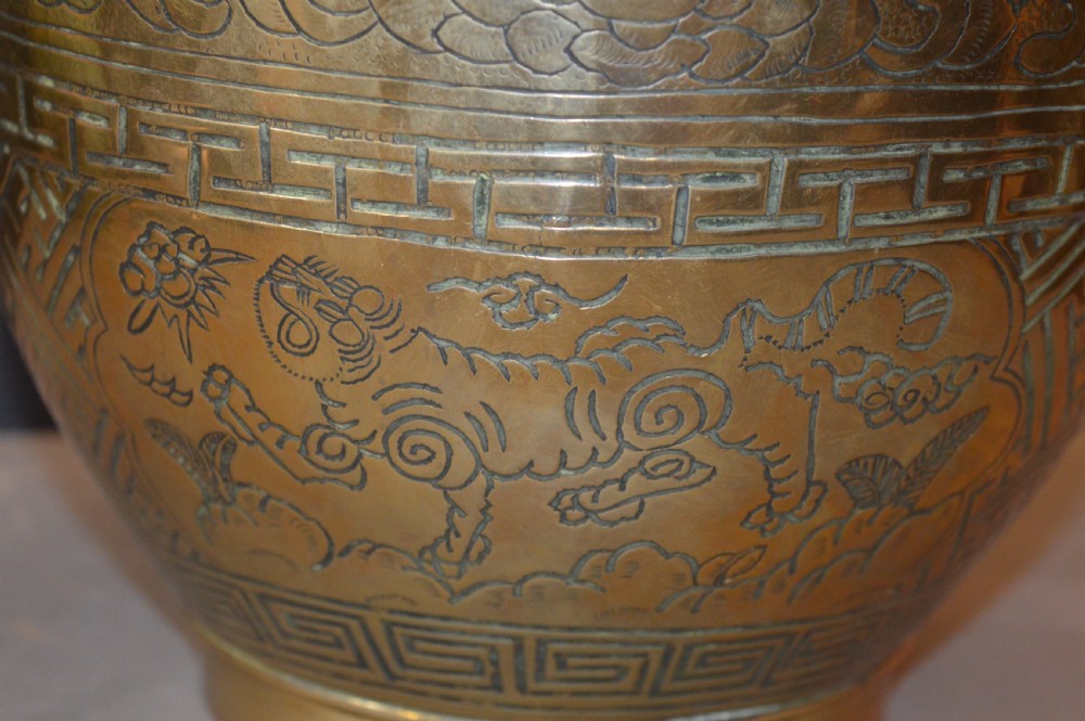 A heavy polished brass Japanese jardiniere with incised dragon artwork and geometric key fret borders around the exterior. View VIII