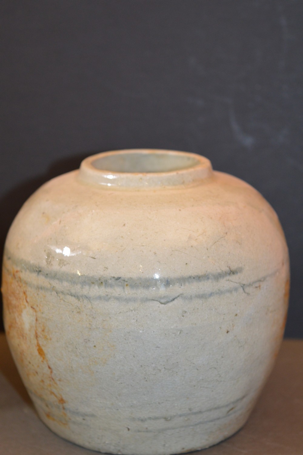 A pair of antique Chinese Ming dynasty ceramic pots featuring short rolled rims, globose bodies, and heavily crackled, patinated cream glazes. View II