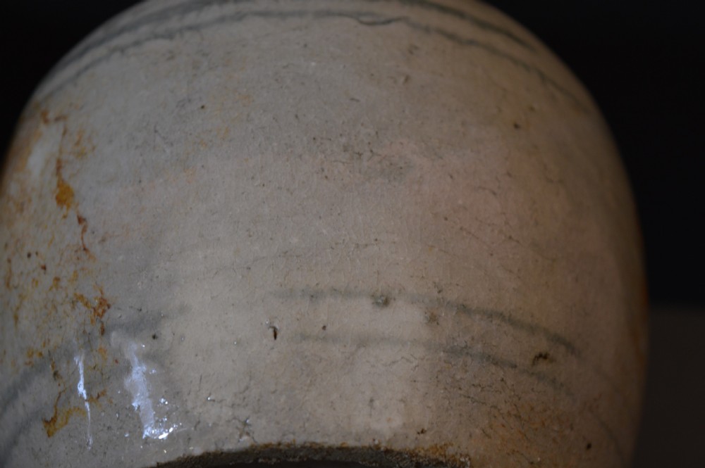 A pair of antique Chinese Ming dynasty ceramic pots featuring short rolled rims, globose bodies, and heavily crackled, patinated cream glazes. View VII
