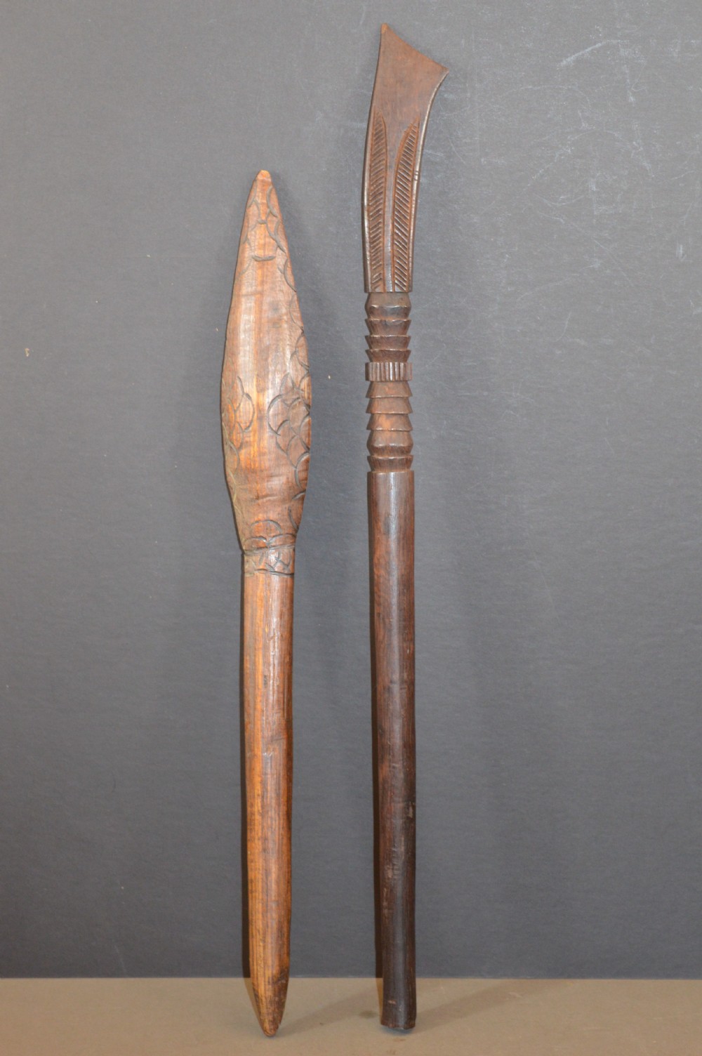 Pair of late nineteenth-century hand-carved dark hardwood Oceanic war clubs featuring geometric carved decoration on the heads.