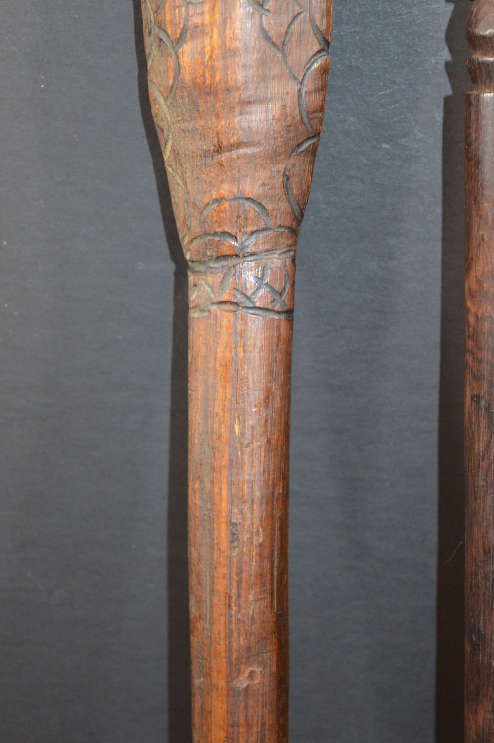 Pair of late nineteenth-century hand-carved dark hardwood Oceanic war clubs featuring geometric carved decoration on the heads. View IV