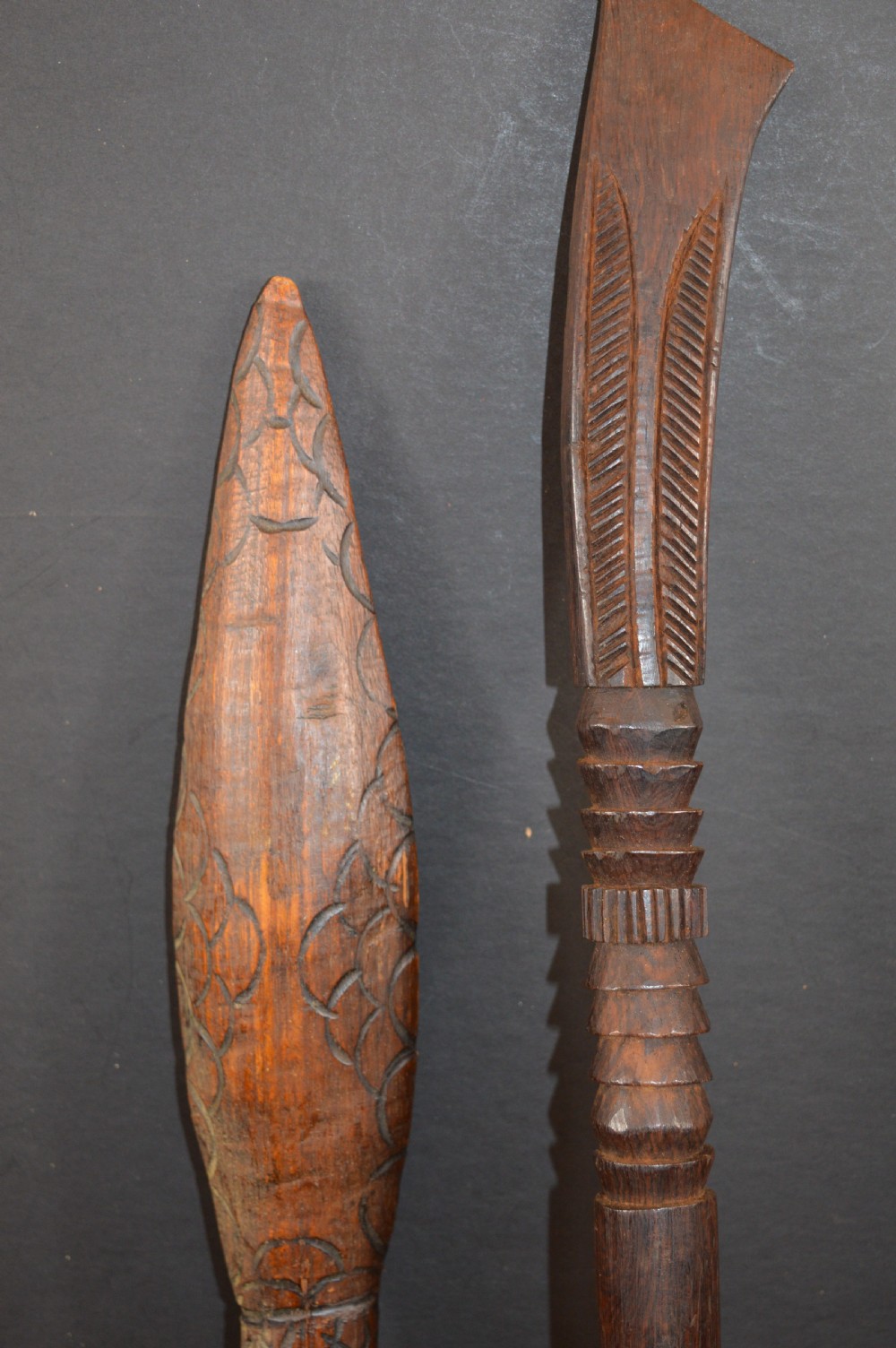 Pair of late nineteenth-century hand-carved dark hardwood Oceanic war clubs featuring geometric carved decoration on the heads. View X