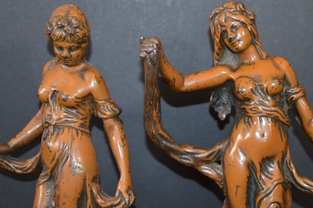 A pair of late nineteenth-century French bronzed metal allegorical female statues titled Modestie and Gaiete, mounted on circular turned wooden bases with brass nameplates. View II
