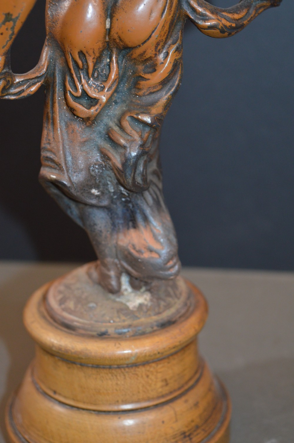 A pair of late nineteenth-century French bronzed metal allegorical female statues titled Modestie and Gaiete, mounted on circular turned wooden bases with brass nameplates. View VIII