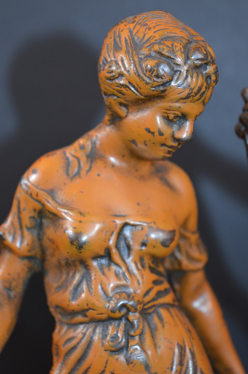 A pair of late nineteenth-century French bronzed metal allegorical female statues titled Modestie and Gaiete, mounted on circular turned wooden bases with brass nameplates. View XI