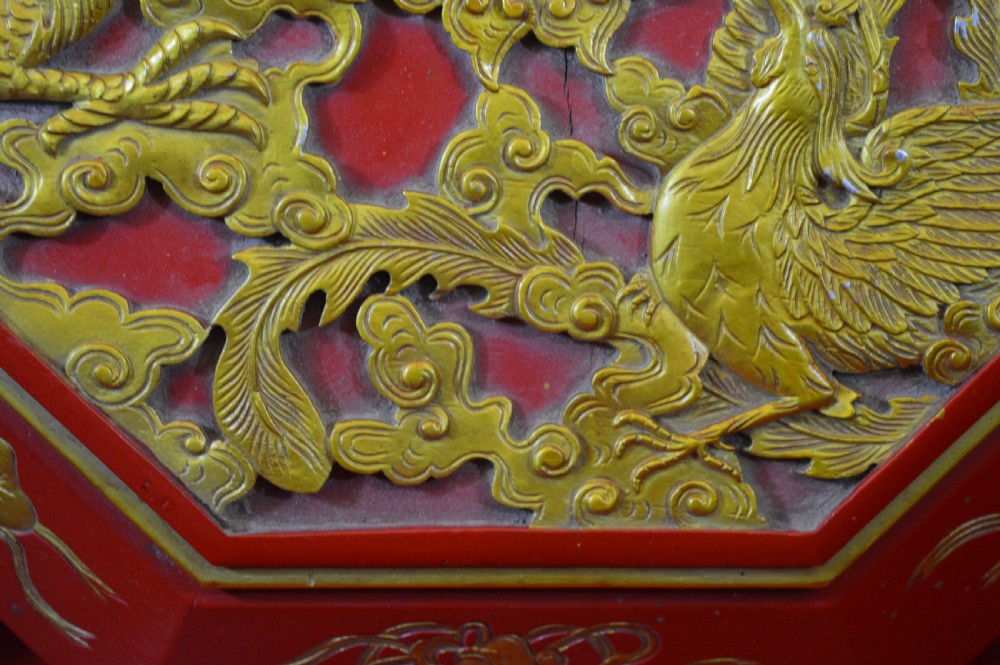 An octagonal Chinese red lacquer wedding box with relief-carved gold dragon and lotus motifs. View XIII