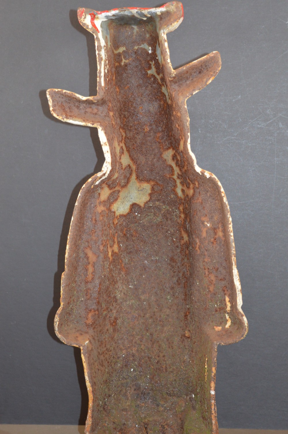 A late 19th-century cast iron figure of a pig dressed in butcher attire with distressed white paint and visible surface oxidisation. View VII