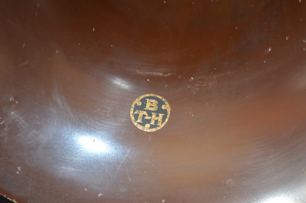 An antique 1930s British Thomson-Houston horn loudspeaker with a flared dark brown Bakelite bell, a curved silver metal neck, and a matching rounded Bakelite base. View V