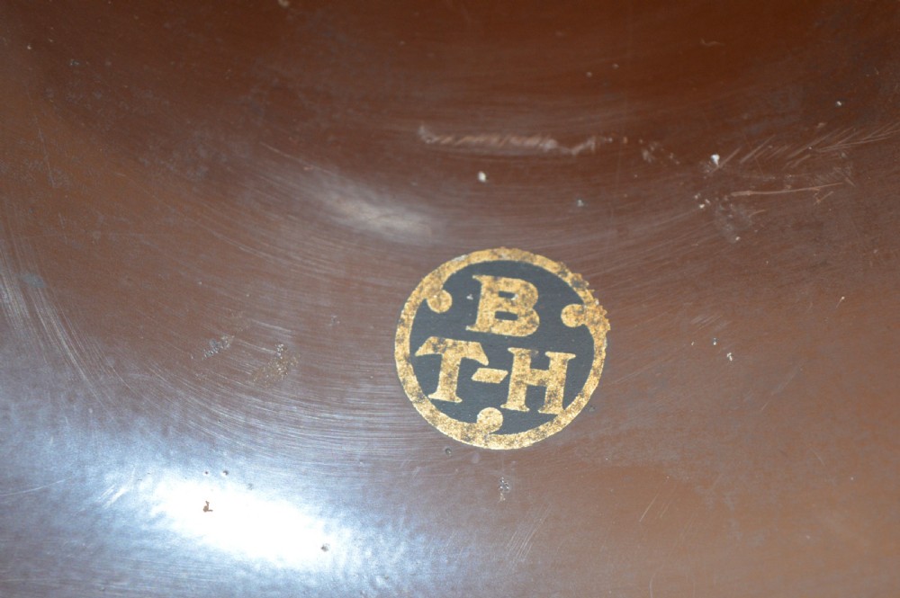 An antique 1930s British Thomson-Houston horn loudspeaker with a flared dark brown Bakelite bell, a curved silver metal neck, and a matching rounded Bakelite base. View VI