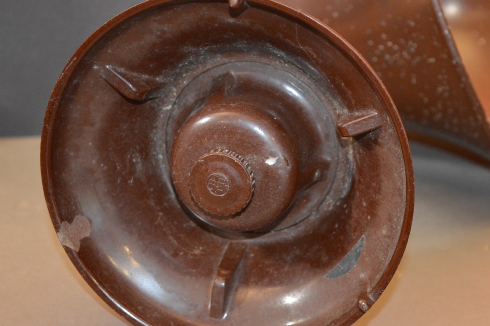 An antique 1930s British Thomson-Houston horn loudspeaker with a flared dark brown Bakelite bell, a curved silver metal neck, and a matching rounded Bakelite base. View XI