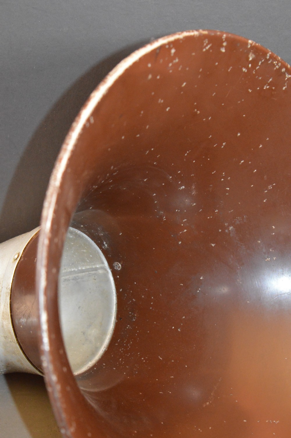 An antique 1930s British Thomson-Houston horn loudspeaker with a flared dark brown Bakelite bell, a curved silver metal neck, and a matching rounded Bakelite base. View XII