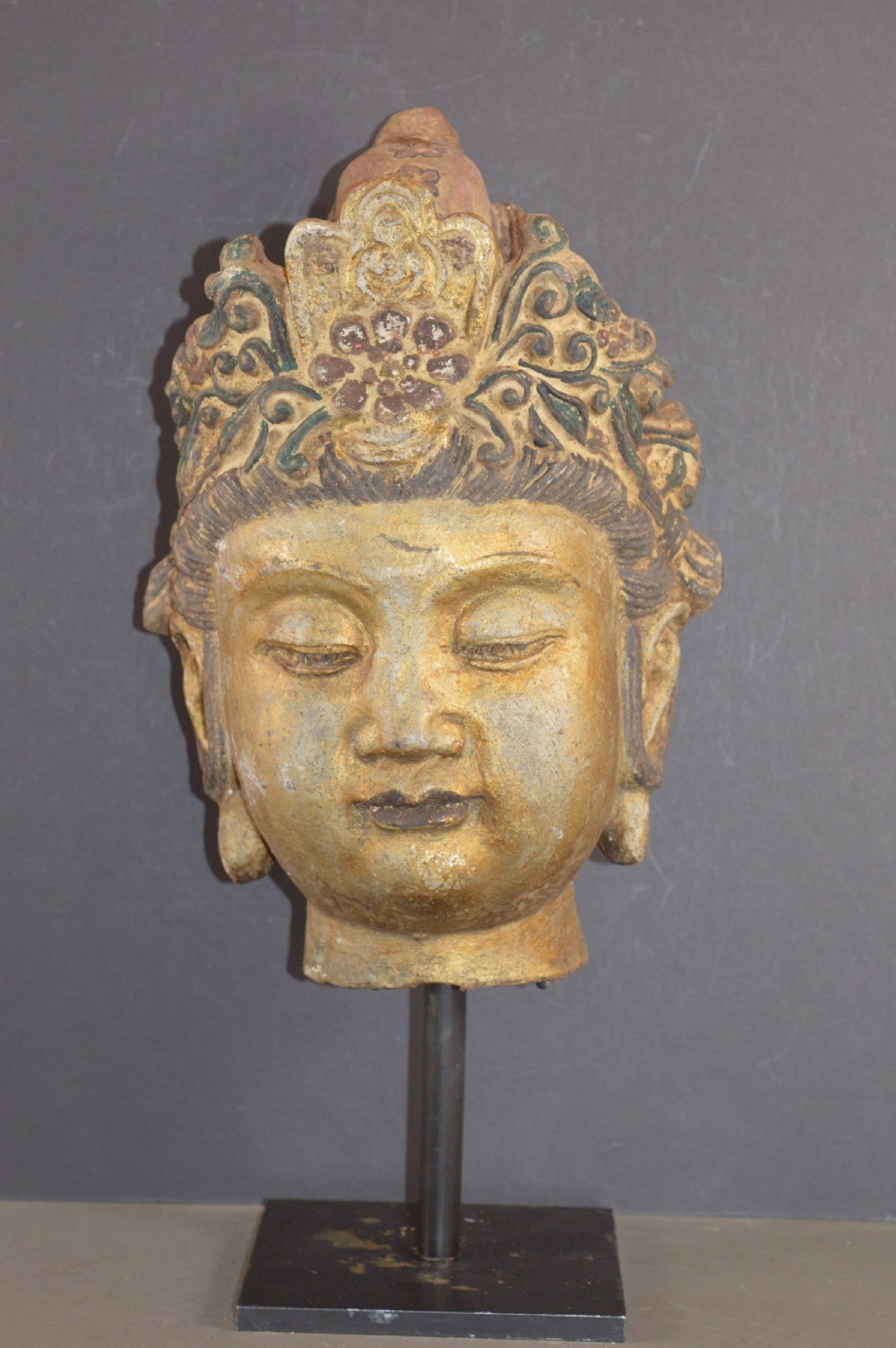 A late 19th-century cast iron head sculpture of Guanyin featuring detailed scrollwork tiara and residual gold gilding. View II