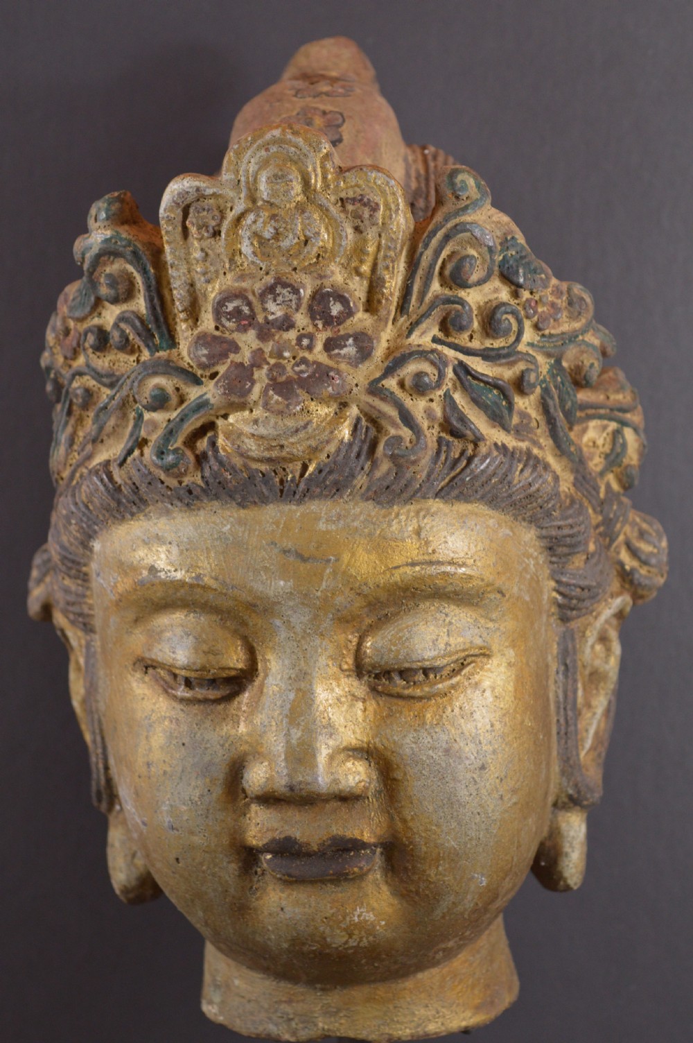 A late 19th-century cast iron head sculpture of Guanyin featuring detailed scrollwork tiara and residual gold gilding. View III