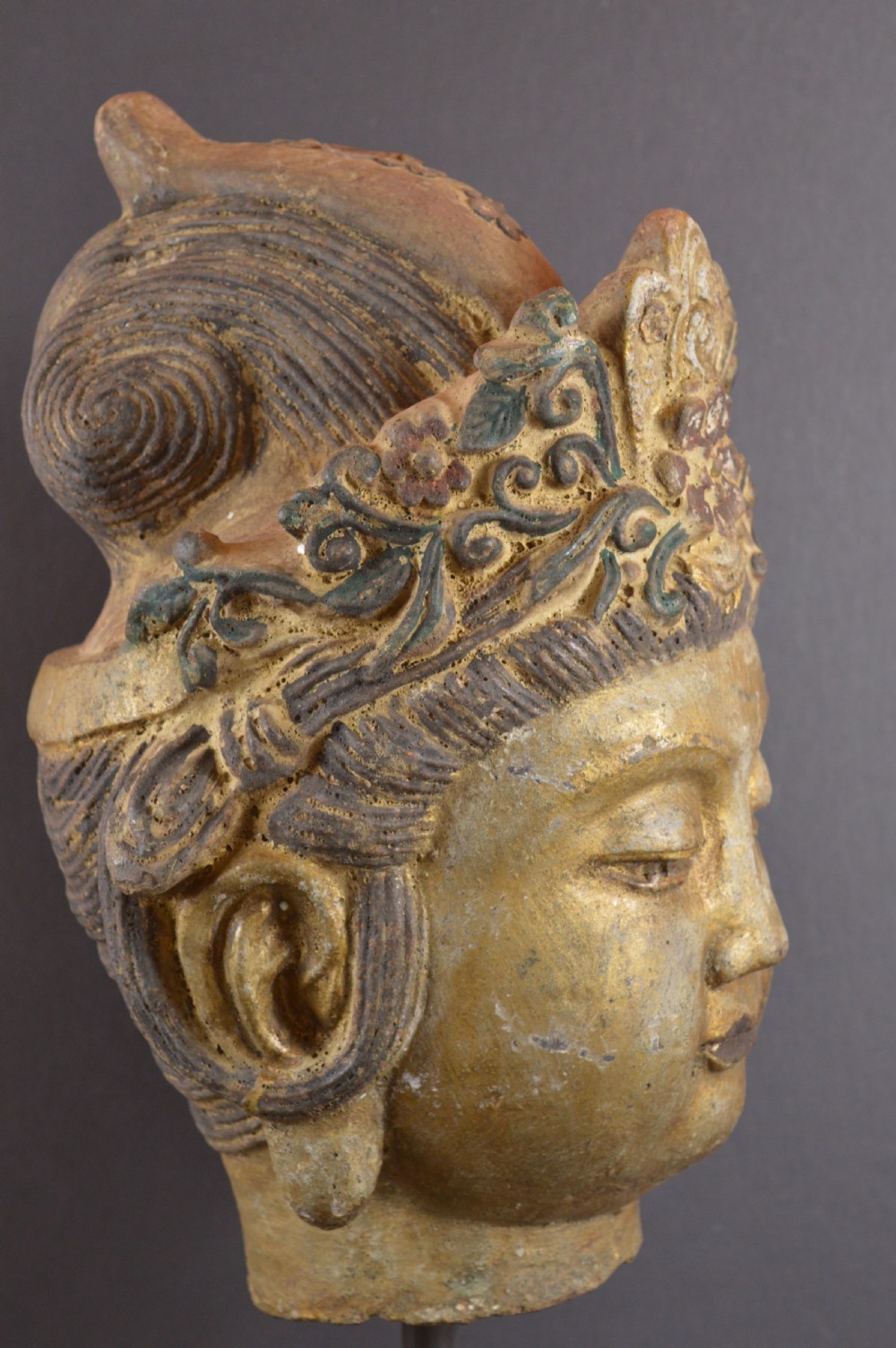 A late 19th-century cast iron head sculpture of Guanyin featuring detailed scrollwork tiara and residual gold gilding. View V